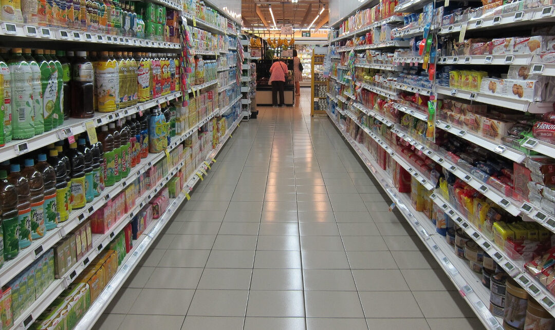 Grocery Store Aisle with Soda and Soft Drinks on the Left and Cookies and Crackers on the Right