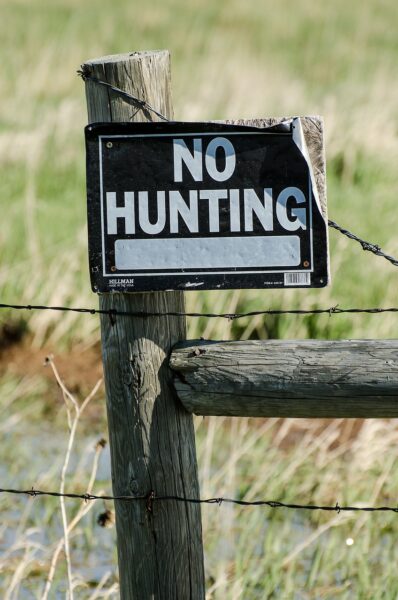 Old No Hunting Sign on an Old Fence Post