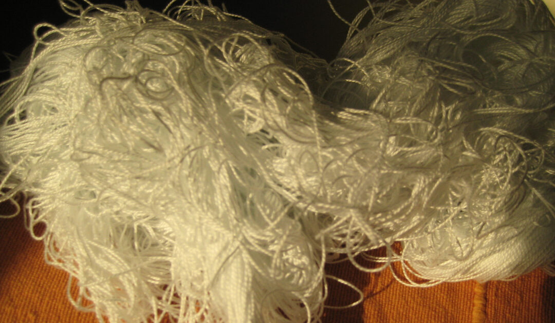 A tangled ball of white yarn with no visible way to untangle it.